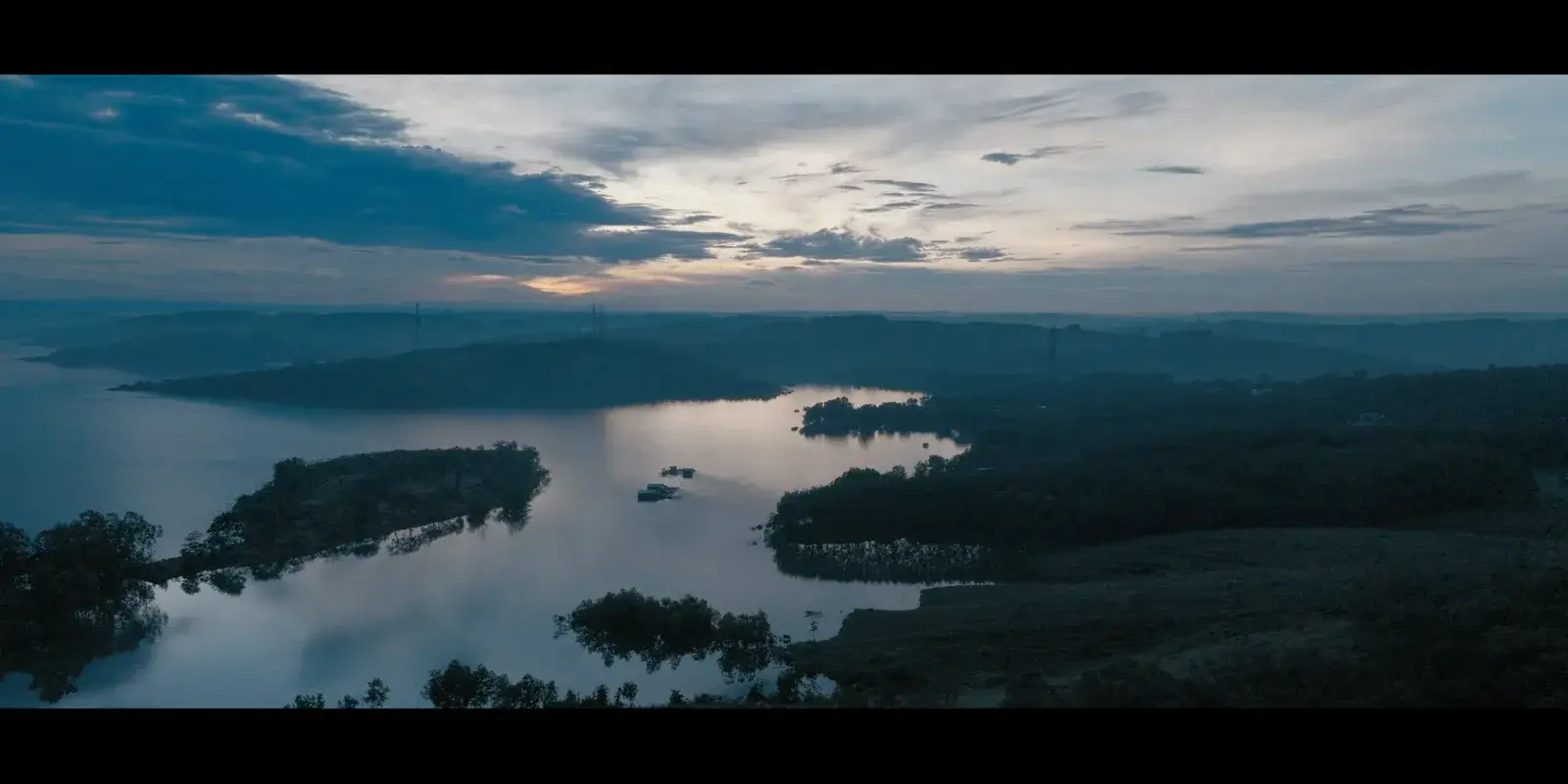 The lake and forest at Nghĩa Trung before sunrise, seen from the air