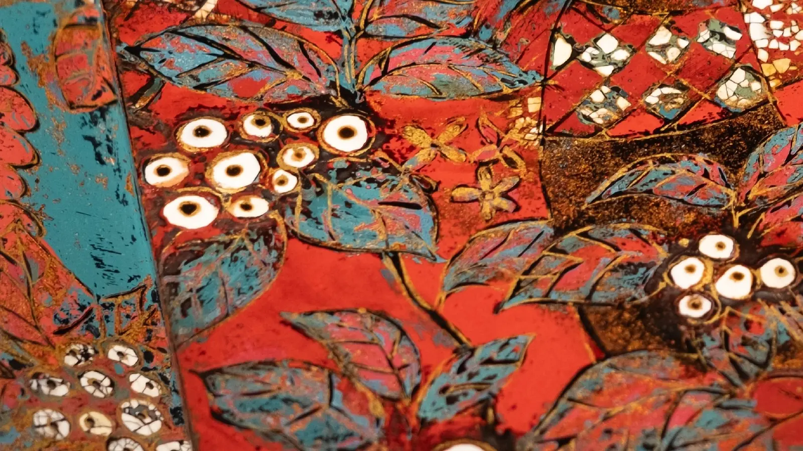 Macro of the coffee cherries drawn in eggshell inlay against the red ground