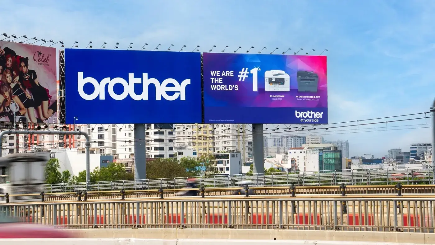 A large roadside billboard carrying the campaign at night