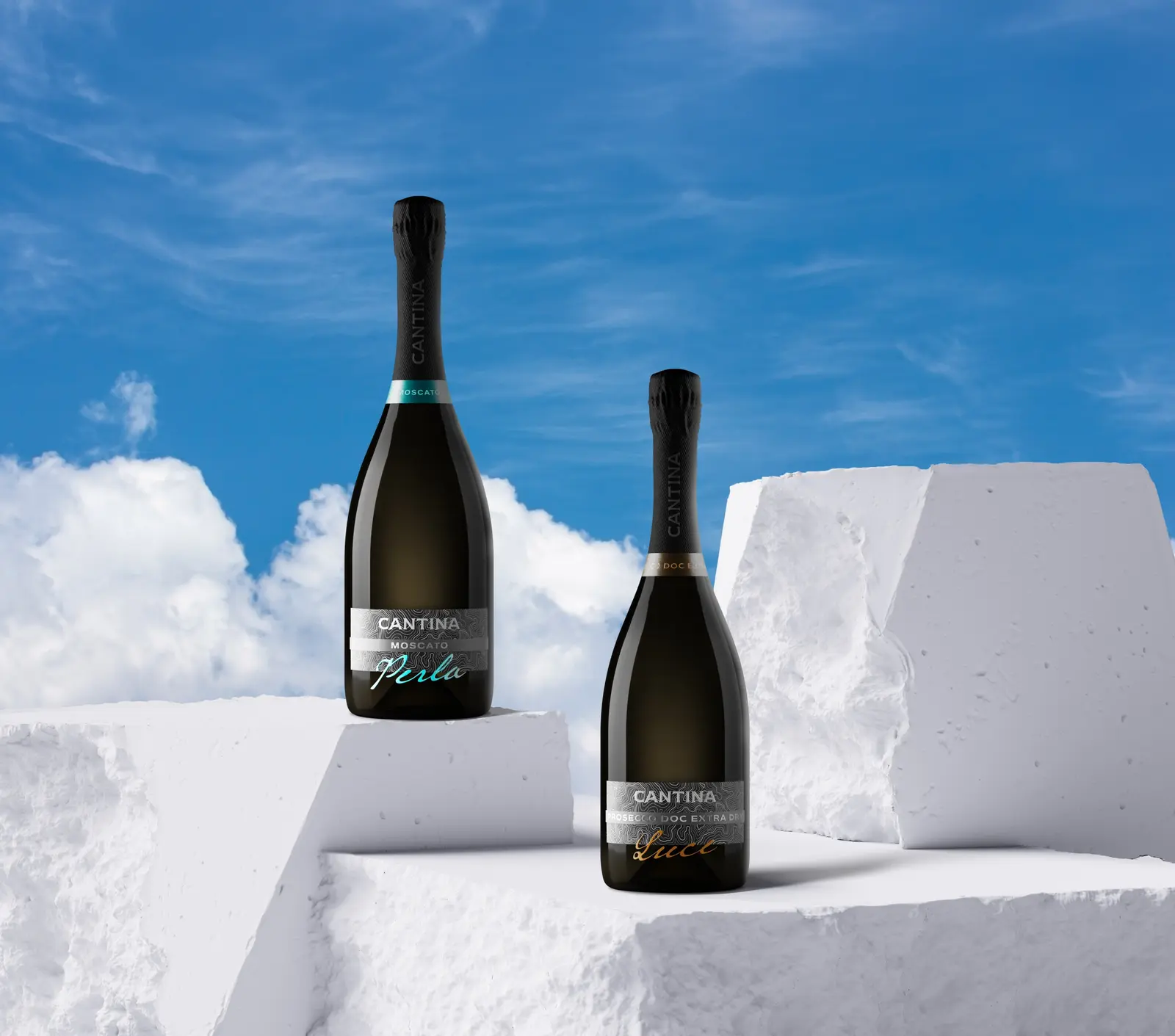 Two bottles standing against a clear sky on white blocks