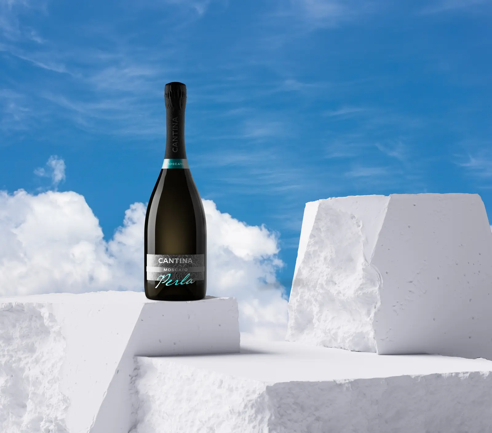 The Perla bottle against a bright sky and white blocks
