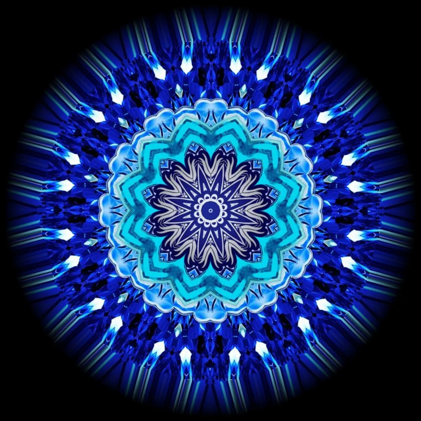 The sapphire kaleidoscope medallion — white and pale blue petals radiating on deep blue