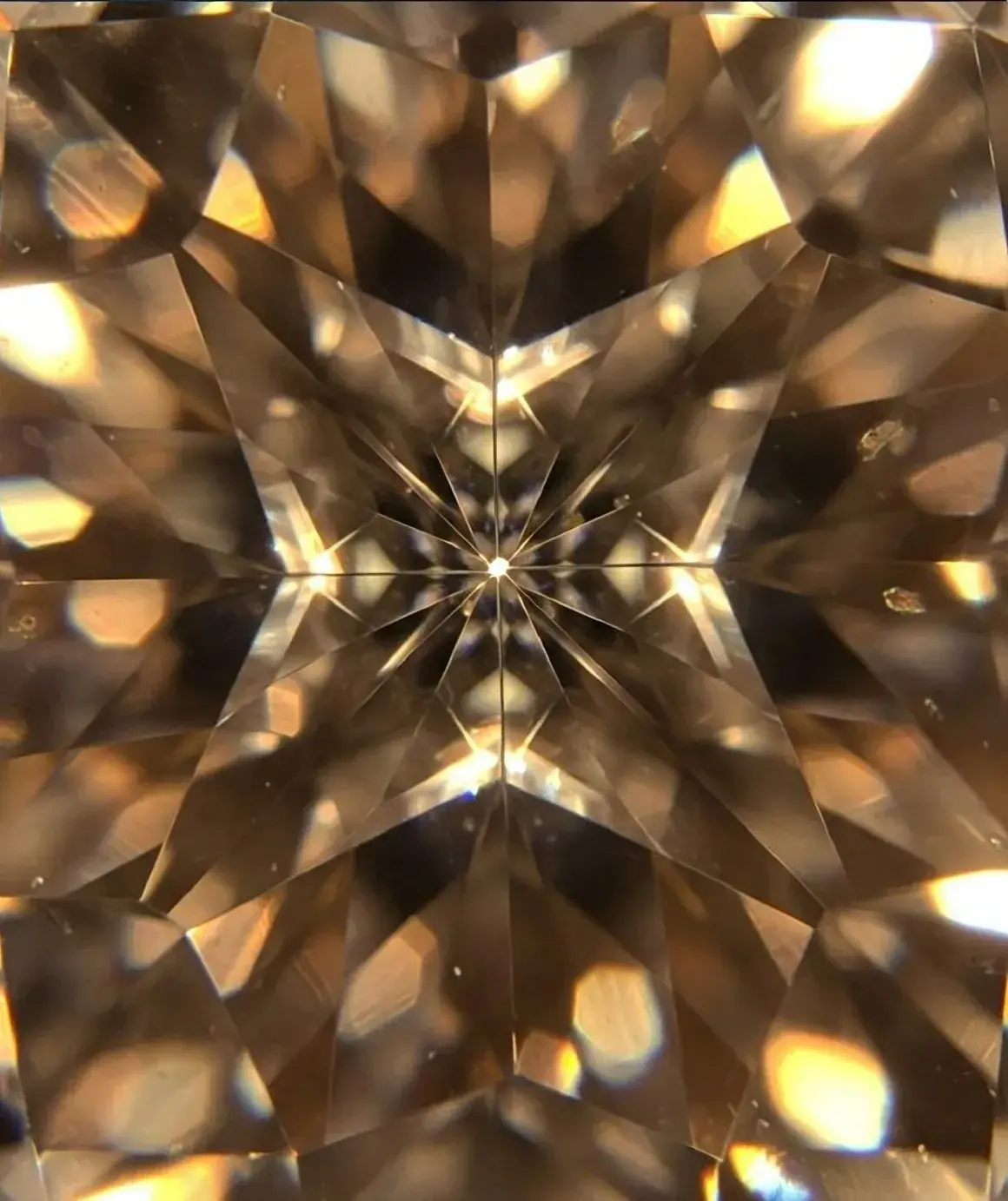A gold kaleidoscope field built from mirrored facets of the same stone