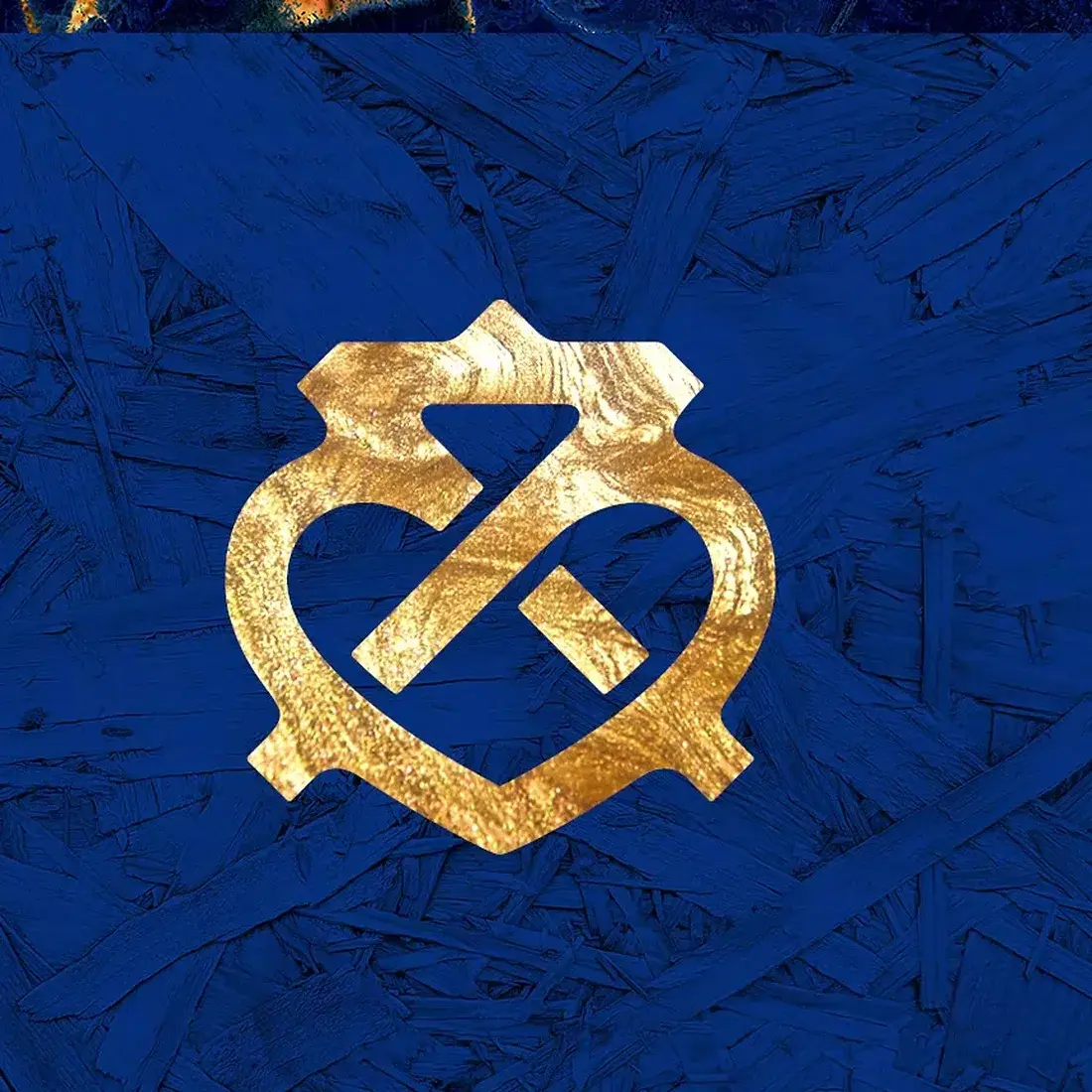 The crest element as used in the XVIII film — gold on blue ink