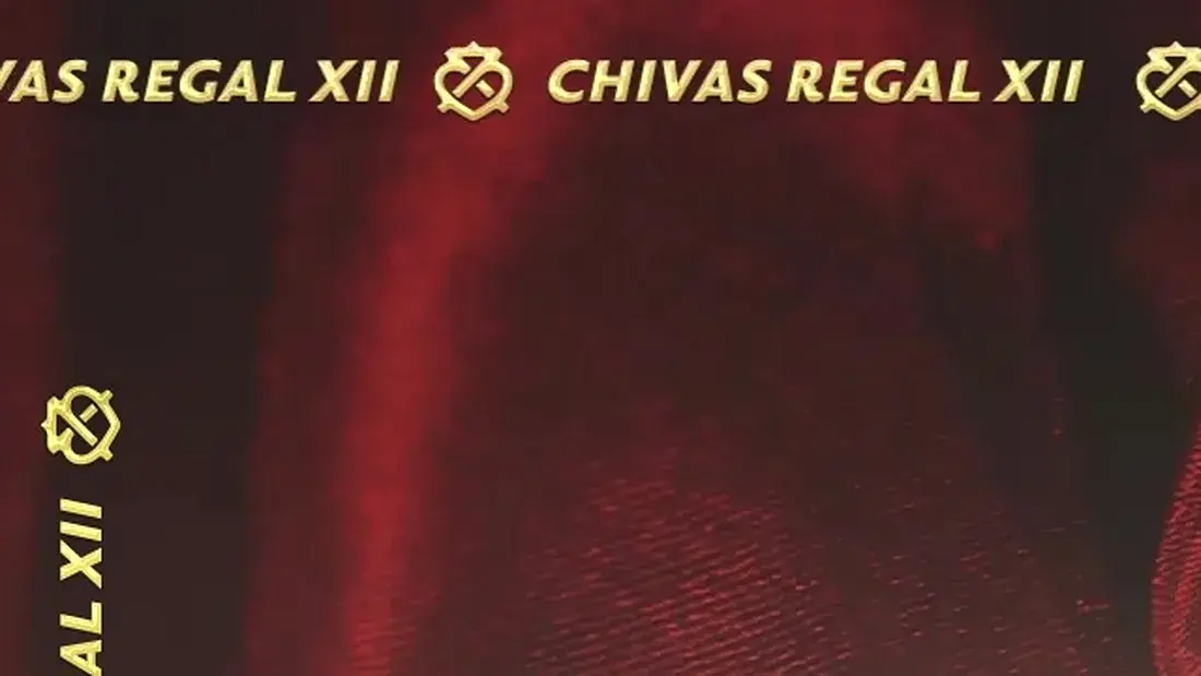 The ticker frame in the XII film — warm gold on red