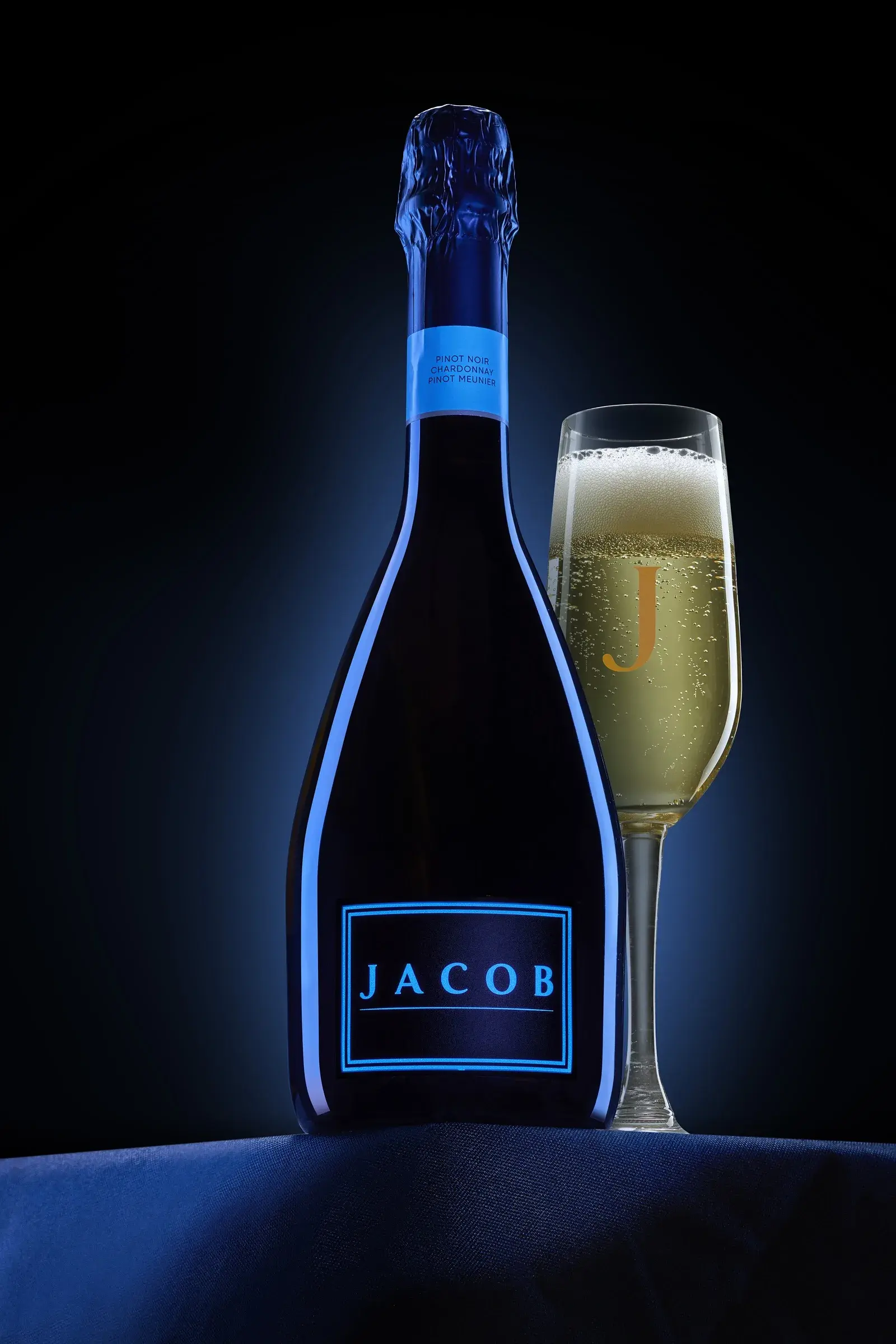 The bottle laid on blue satin, folds catching the light