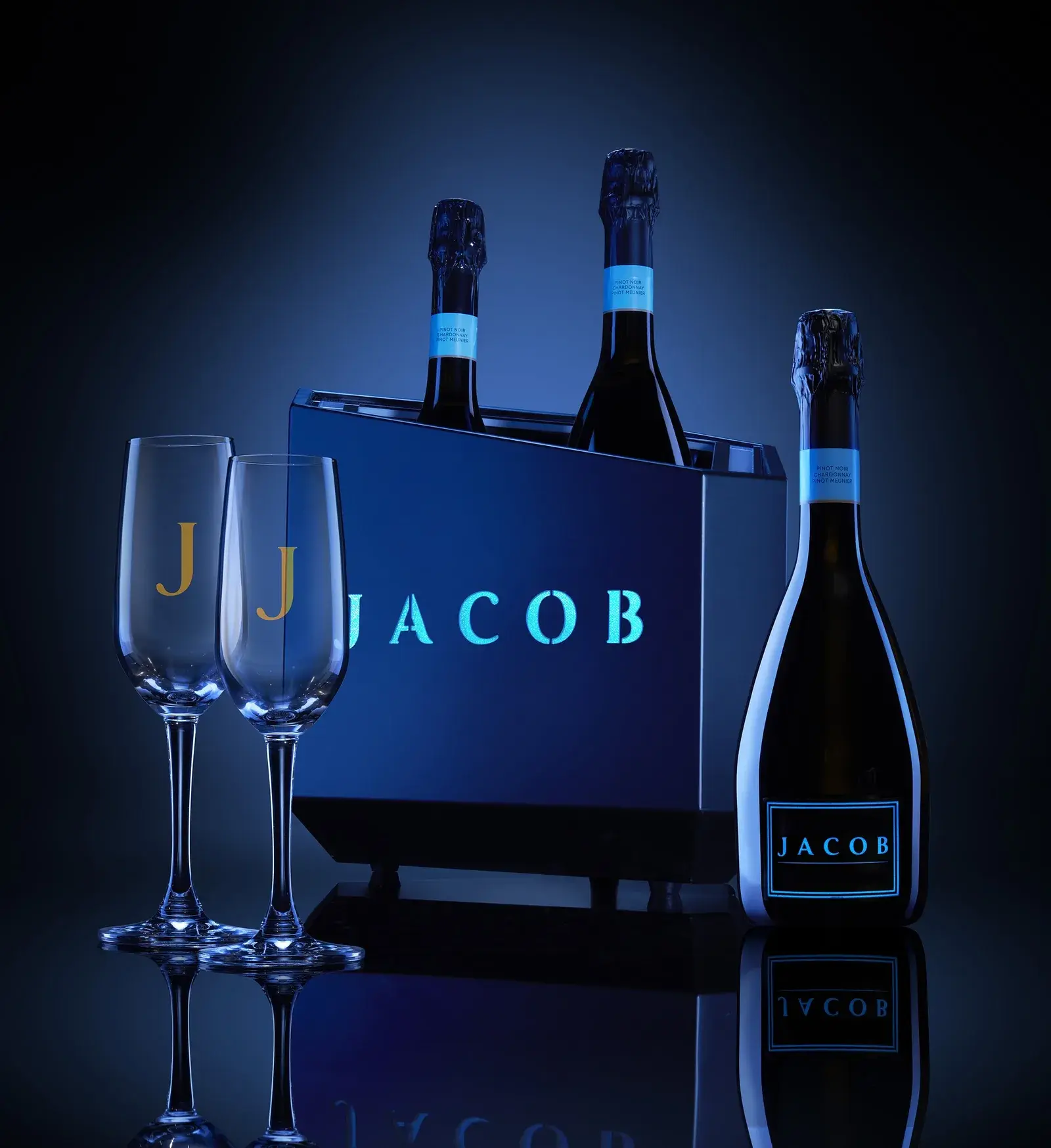 Three-bottle carrier with glassware arranged around it