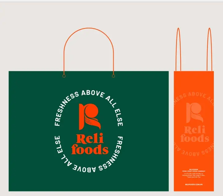 Paper carrier bags — green with the stamp, orange with the monogram
