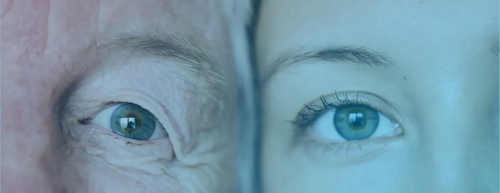 Macro photograph of a pair of eyes, iris lit in cyan
