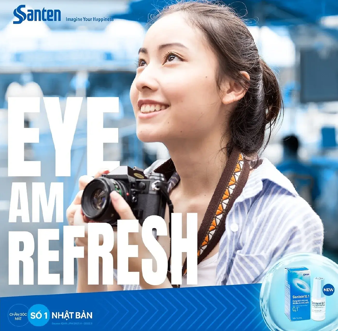 Post concept — Eye Am Refresh, a woman with a camera against blue