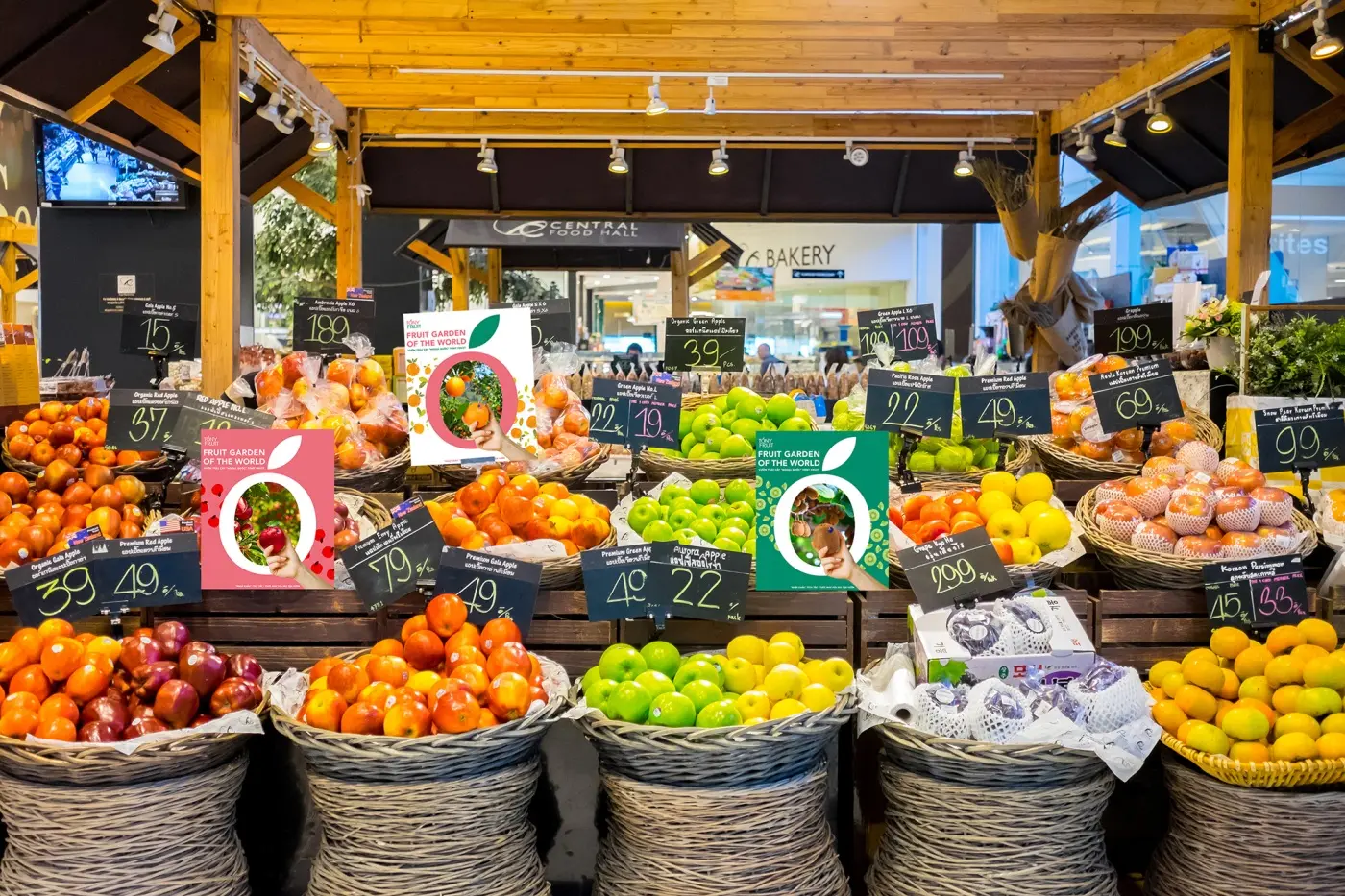 A market stall dressed in the identity, produce baskets under the branded canopy